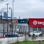 Razor wire surrounding the Minneapolis Police Third precinct parking lot. Target can been seen across the street. The Target was rebuilt after suffering damage during the riots that followed the May 25, 2020 murder of George Floyd by the Minneapolis police.