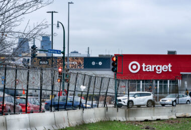 Razor wire surrounding the Minneapolis Police Third precinct parking lot. Target can been seen across the street. 

The Target was rebuilt after suffering damage during the riots that followed the May 25, 2020 murder of George Floyd by the Minneapolis police.