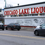Graffiti on metal shutters covering the windows of Chicago Lake Liquors on Lake Street in Minneapolis.