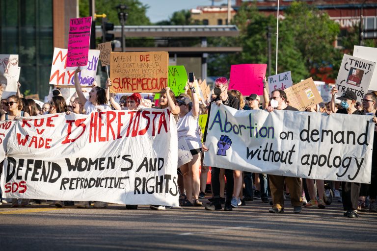 Abortion Rights March Down Downtown Minneapolis Street 1 Demonstrators carry banners and signs supporting abortion rights during a march through downtown Minneapolis.
