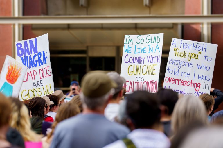 Abortion Rights Protest Signs, Downtown Minneapolis 2 Protesters hold hand-lettered signs about abortion rights and gun control during a downtown Minneapolis demonstration.
