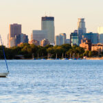A sailboat on Bde Maka Ska in Minneapolis during sunset.