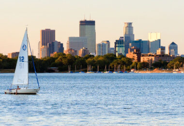 A sailboat on Bde Maka Ska in Minneapolis during sunset.