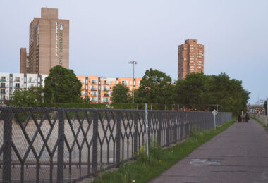A family walks down a trail near Riverside Plaza in Minneapolis.