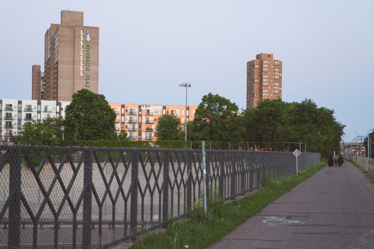 Riverside Plaza in Minneapolis 3 A family walks down a trail near Riverside Plaza in Minneapolis.