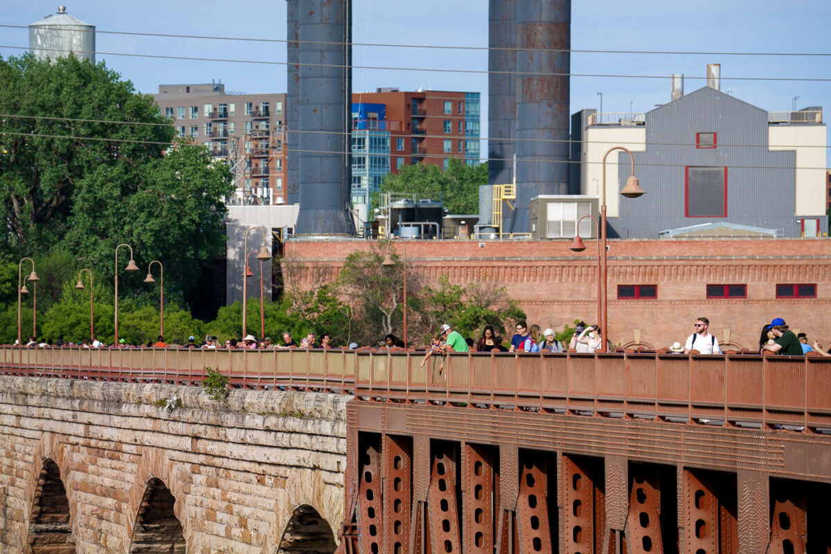 People on the Stone Arch Bridge on a summer day. The historic bridge is over the Mississippi River.