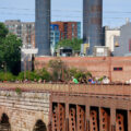 People on the Stone Arch Bridge on a summer day. The historic bridge is over the Mississippi River.