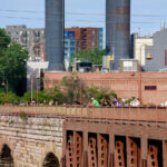 People on the Stone Arch Bridge on a summer day. The historic bridge is over the Mississippi River.