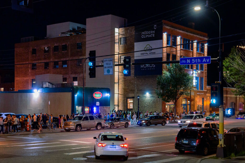 Bar patrons standing in line on Washington Avenue.