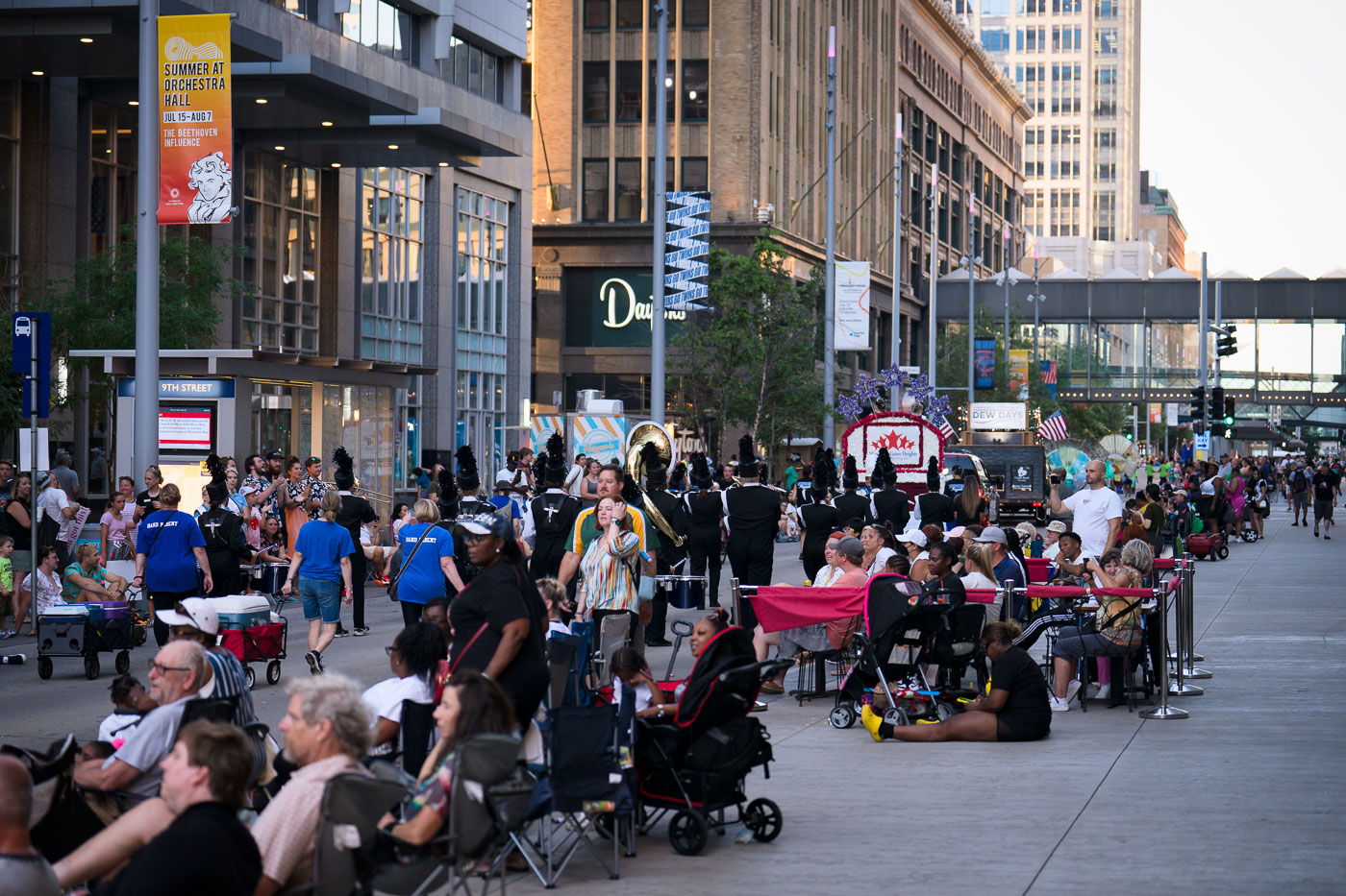 A marching band performs during the Minneapolis Torchlight Parade on Nicollet Mall on July 20, 2022. Nicollet Mall, a pedestrian promenade in downtown Minneapolis, serves as a primary venue for public events and celebrations. The mall's design facilitates large gatherings, and parades like this one are a recurring feature, underscoring its role in the city's cultural and civic life. The presence of spectators and performers highlights the mall's function as a central space for community engagement.