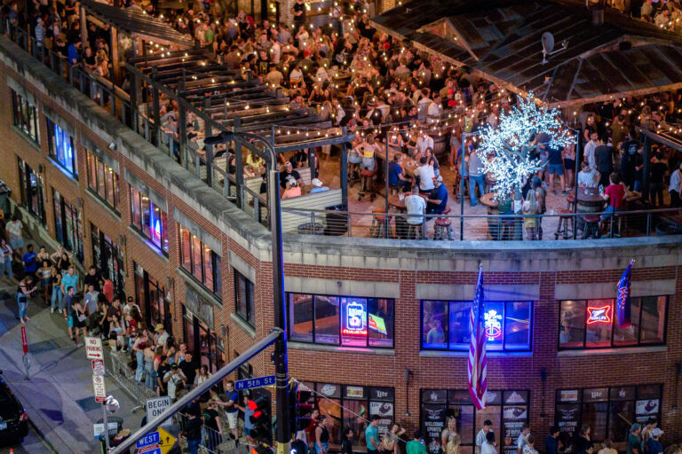 Cowboy Jack's, Downtown Minneapolis, July 2022 3 In July 2022, patrons filled the multi-level outdoor seating area of Cowboy Jack's, a bar in downtown Minneapolis, Minnesota. The establishment, illuminated by string lights, was a hub of activity during a period of resurgence for the city's nightlife following the 2020 Minneapolis Uprising. This event significantly impacted the downtown area, and the return of public gatherings at venues like Cowboy Jack's marked a step towards normalcy.