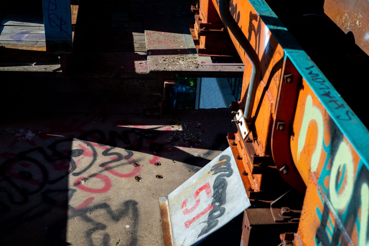 Graffitied industrial machinery and rusted metal components inside the abandoned Fruen Mill in Minneapolis.