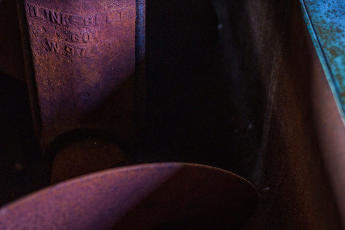 Rusted industrial machinery and stamped metal inside the abandoned Fruen Mill, Minneapolis.