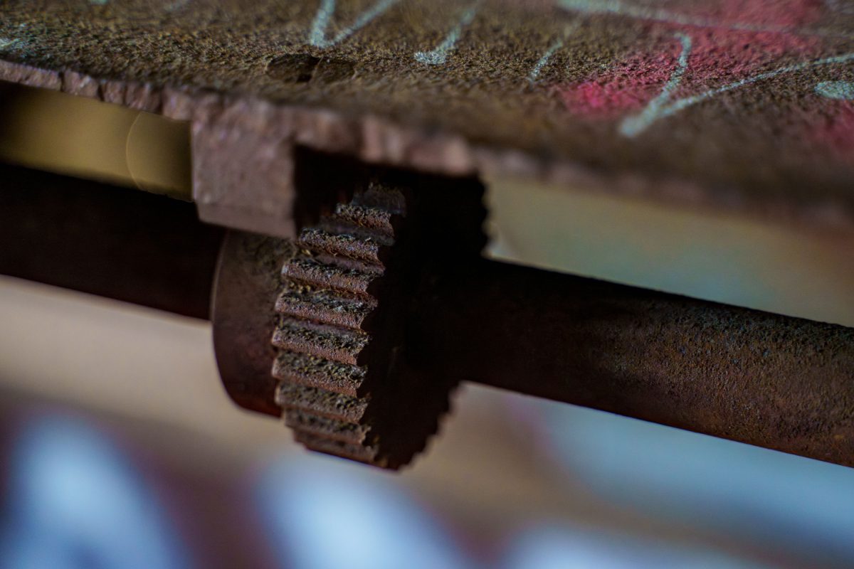 Rusted gear and metal rod inside the abandoned Fruen Mill in Minneapolis.
