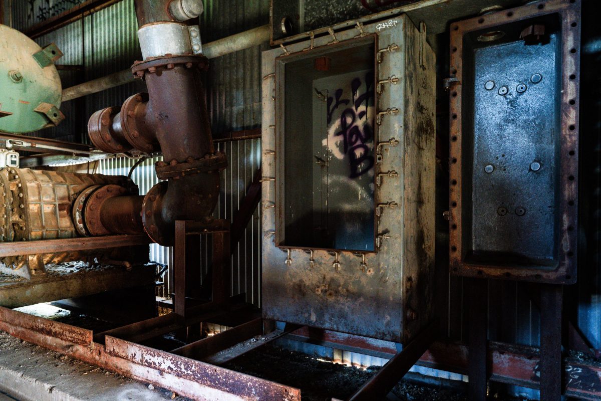 Rusted industrial machinery and metal structures inside the abandoned Fruen Mill in Minneapolis.