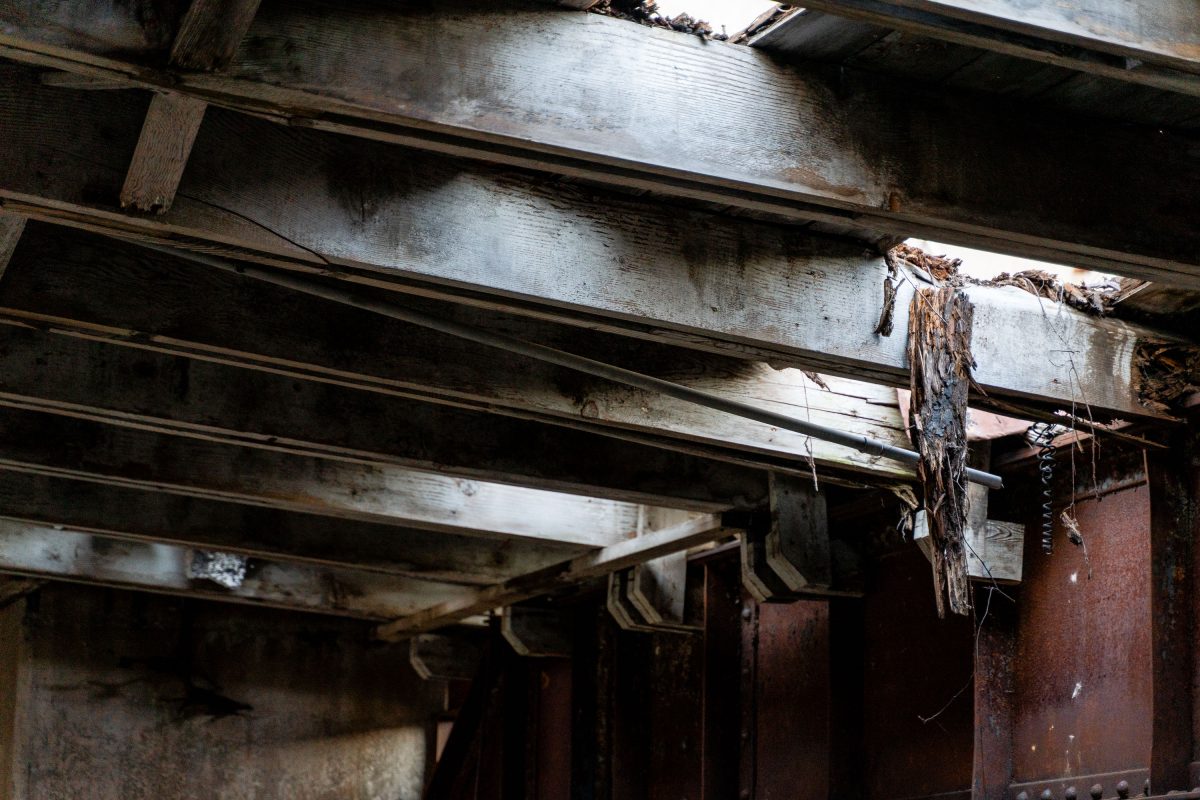 Deteriorating wooden structural beams and rusted metal fixtures inside the abandoned Fruen Mill in Minneapolis.