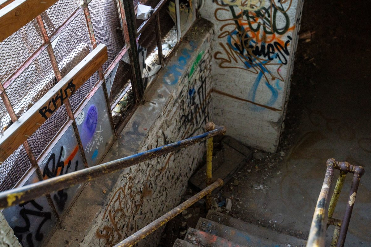 Graffitied industrial machinery and rusted metal framework inside the abandoned Fruen Mill in Minneapolis.