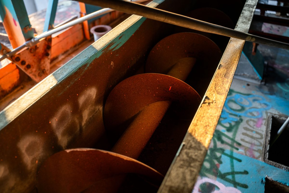 Rusted metal drums and industrial equipment inside the abandoned Fruen Mill in Minneapolis.