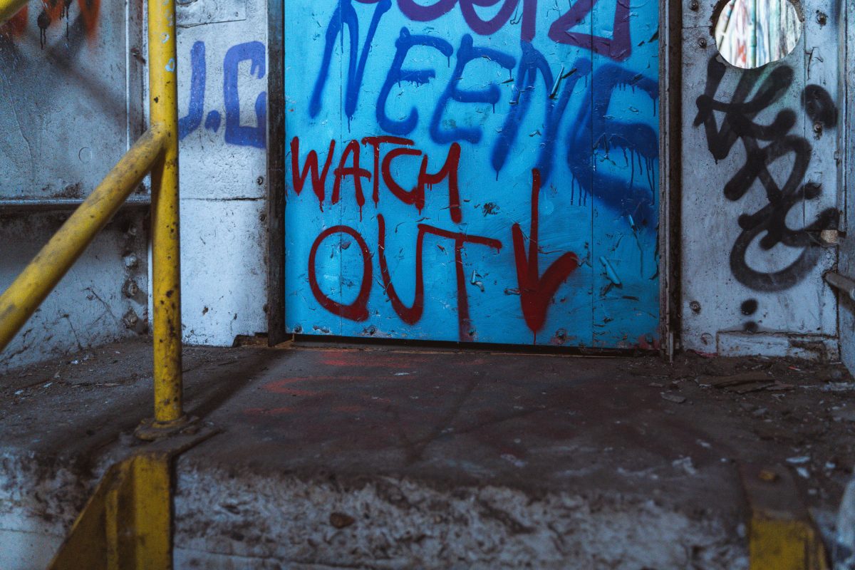 Graffiti-covered walls and yellow metal beam inside the abandoned Fruen Mill in Minneapolis.