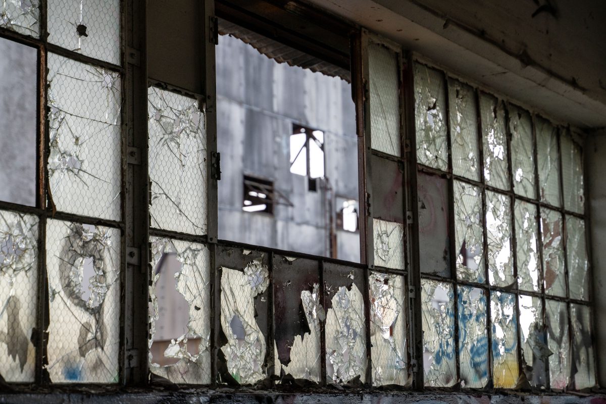 Deteriorating windows with peeling paint inside the abandoned Fruen Mill in Minneapolis.