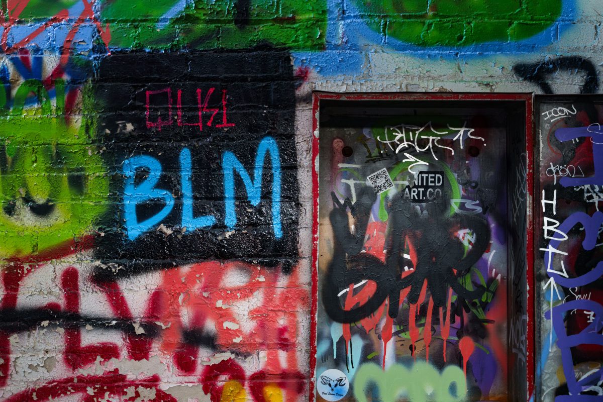 Colorful graffiti covers brick walls and a red-framed window inside the abandoned Fruen Mill in Minneapolis.