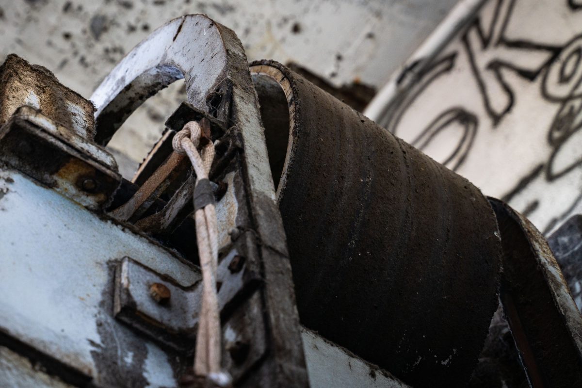 Rusted pulley and hook mechanism inside the abandoned Fruen Mill industrial complex in Minneapolis.