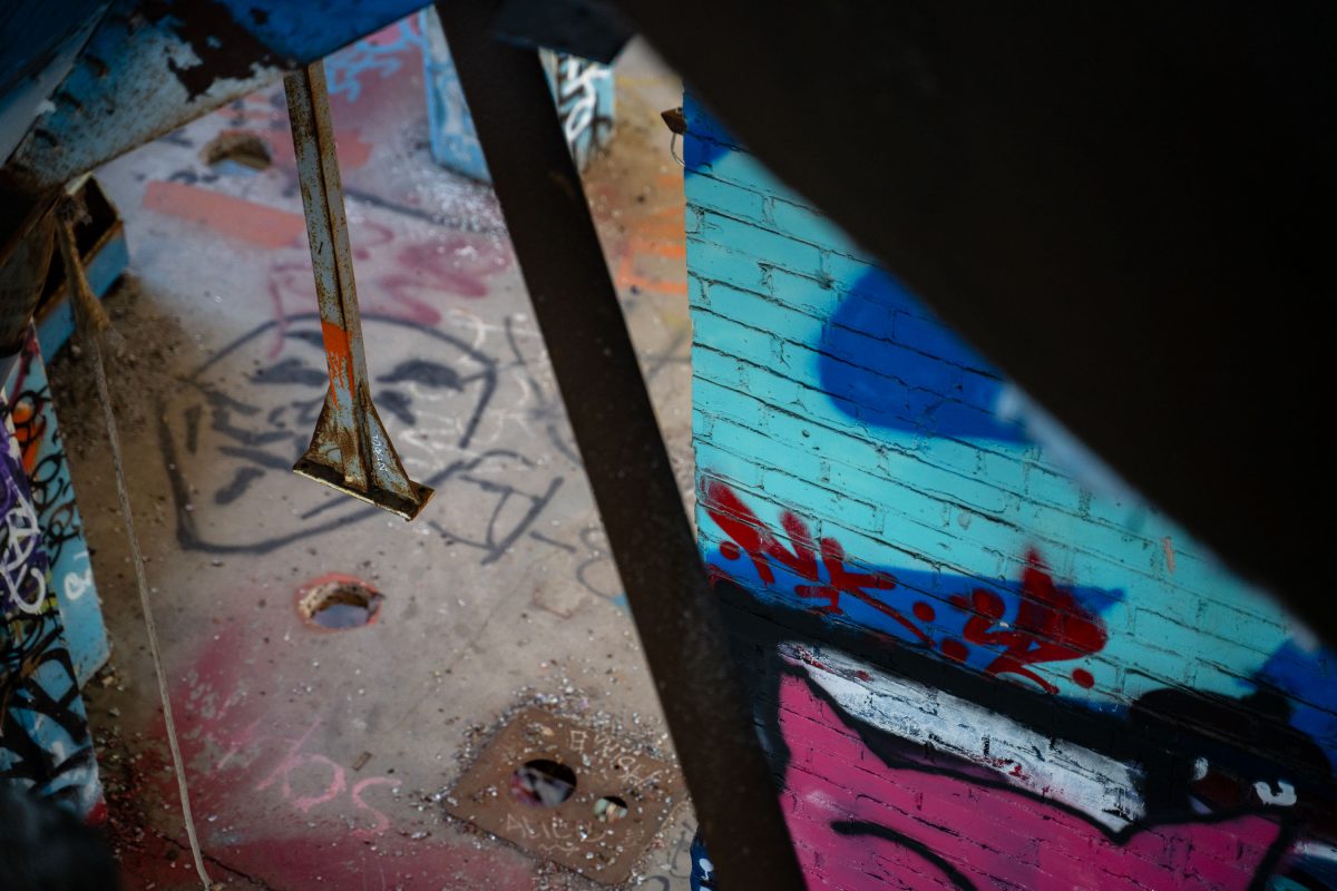 Rusted industrial machinery and colorful graffiti inside the abandoned Fruen Mill in Minneapolis.