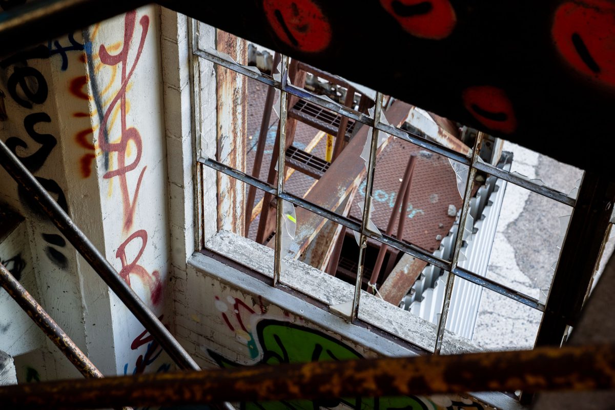 Graffitied industrial window and weathered brick walls inside the abandoned Fruen Mill in Minneapolis.