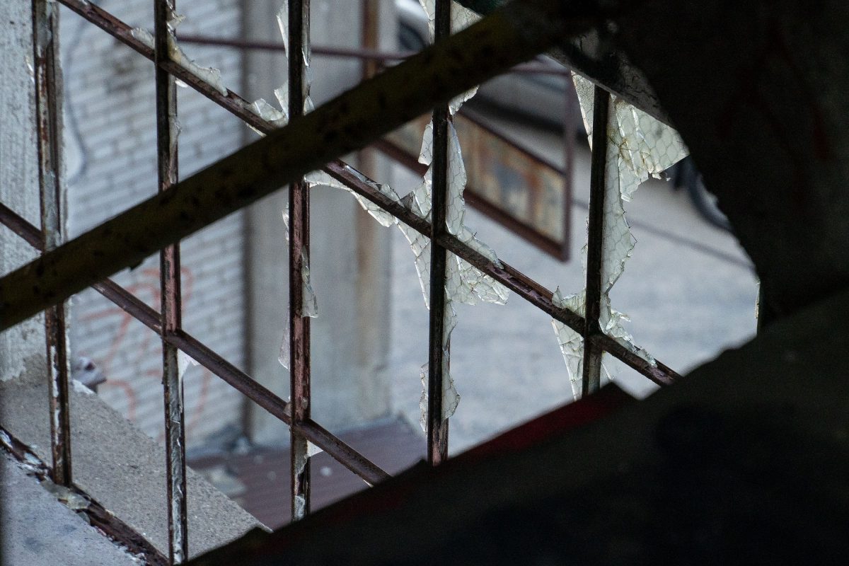 Rusted metal window grating with peeling paint inside the abandoned Fruen Mill in Minneapolis.