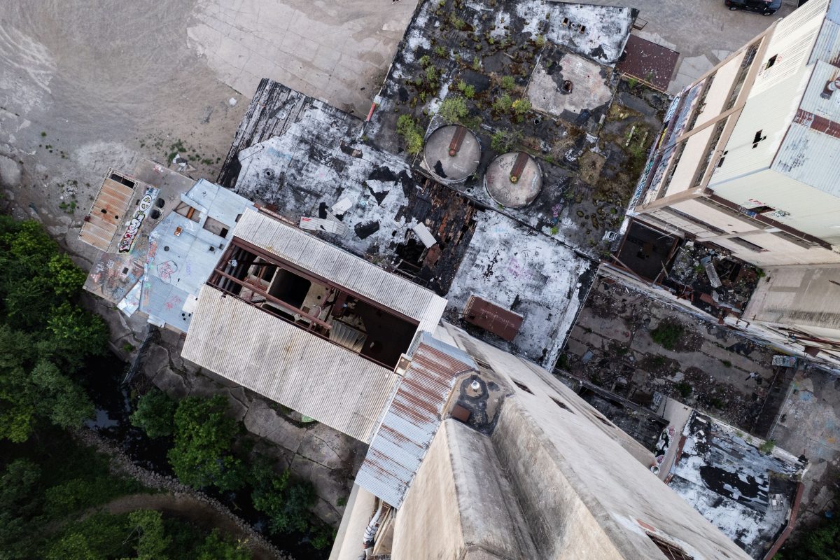 Aerial view of the abandoned Fruen Mill complex in Minneapolis showing deteriorating rooftops, graffiti, and industrial