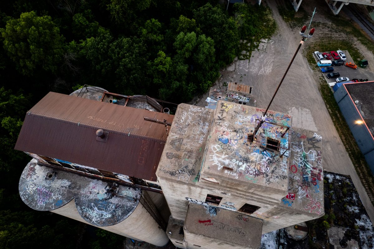 Aerial view of abandoned Fruen Mill complex in Minneapolis showing graffiti-covered concrete structures and industrial buildings