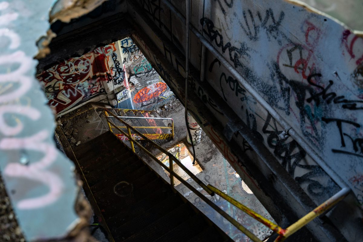 Graffiti-covered industrial equipment and metal structural elements inside the abandoned Fruen Mill in Minneapolis.