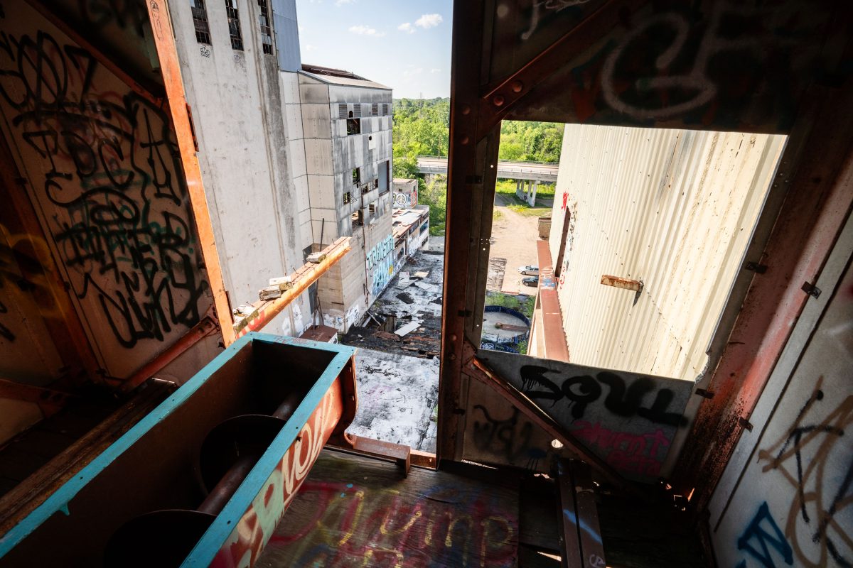 Interior view of the abandoned Fruen Mill in Minneapolis showing rusted industrial machinery and graffiti.