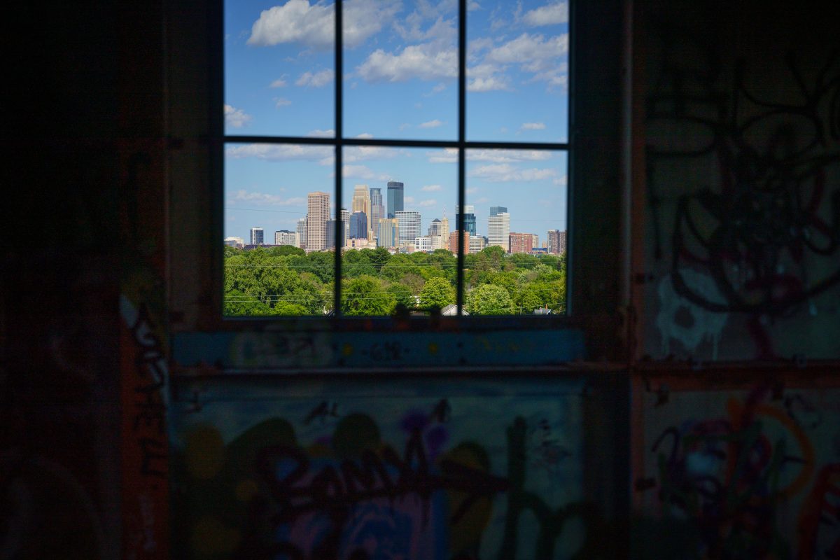 Minneapolis skyline viewed through a window inside the abandoned Fruen Mill.