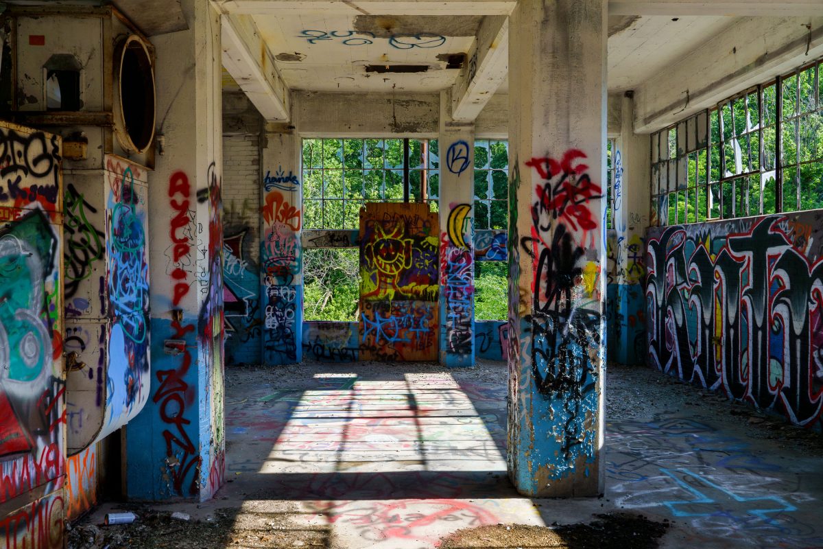 Abandoned interior hallway of Fruen Mill in Minneapolis covered with colorful graffiti.