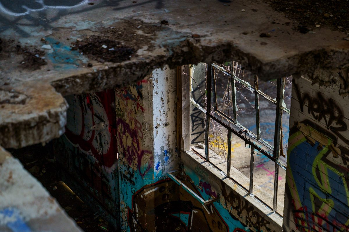Abandoned Fruen Mill interior in Minneapolis showing deteriorated walls with graffiti and broken windows.