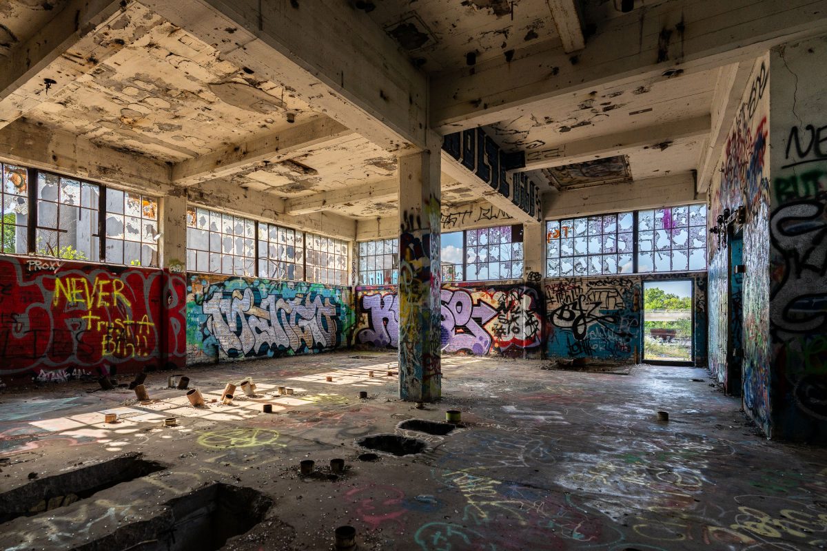 Abandoned interior of Fruen Mill in Minneapolis with graffiti-covered walls and deteriorating ceiling.