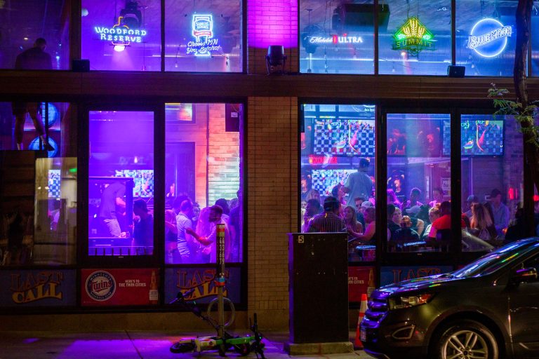 Minneapolis Nightclub, July 2022: Neon Signs & Last Call 1 Last Call nightclub in downtown Minneapolis with neon beer signs and a crowded interior at night.
