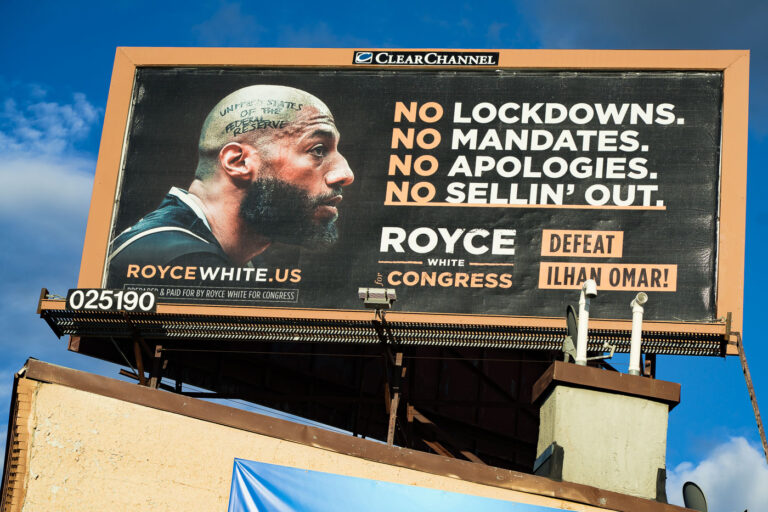 Royce White for Congress Billboard, Lake Street, Minneapolis 2 A billboard on Lake Street in Minneapolis promotes Royce White's campaign for Congress, directly challenging incumbent Ilhan Omar. The advertisement features slogans such as "NO LOCKDOWNS. NO MANDATES. NO APOLOGIES. NO SELLIN' OUT." and "DEFEAT ILHAN OMAR!". Paid for by Royce White for Congress, this billboard was a visible element of the political discourse in Minneapolis during the election cycle. The imagery on the billboard includes White's portrait with text on his head referencing "UNITED STATES OF THE FEDERAL RESERVE."
