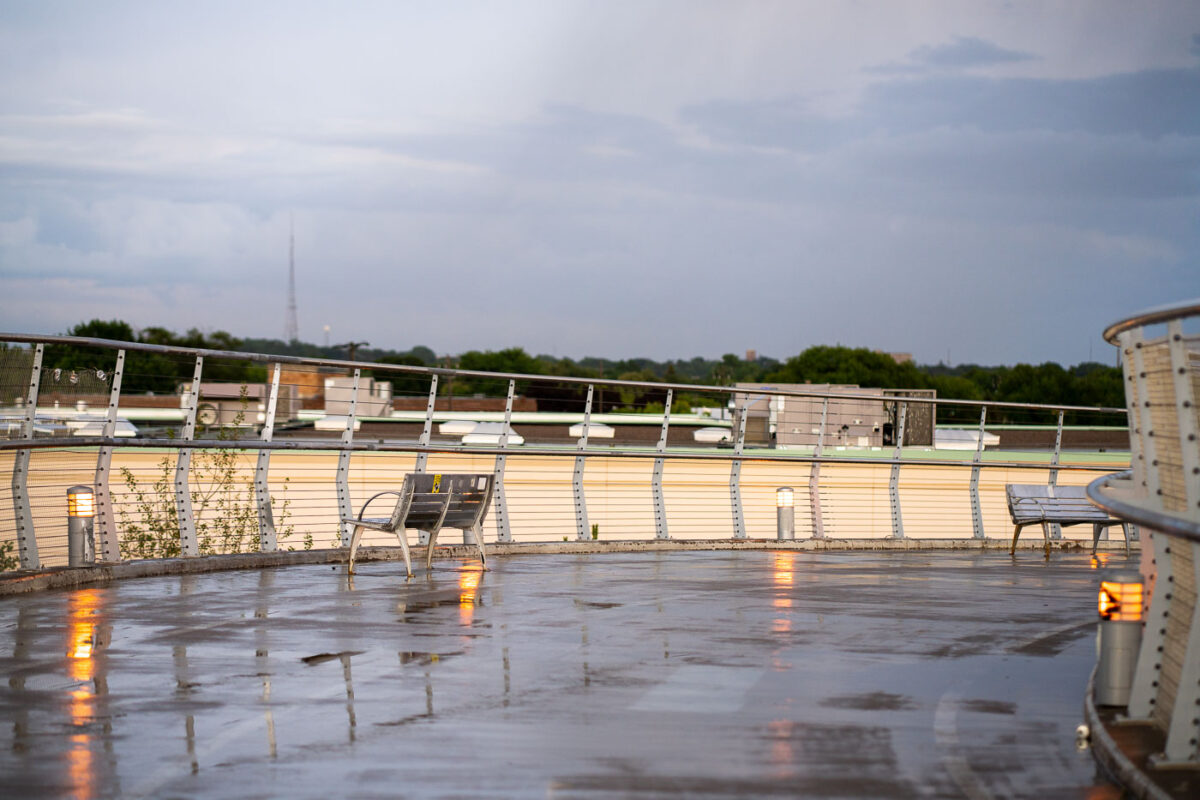 The Martin Olav Sabo Bridge in Minneapolis, also known as the "Hiawatha Line Bridge," is a pedestrian and bicycle bridge that opened in 2002. It spans the Hiawatha Avenue Light Rail corridor, connecting the Longfellow and Cooper neighborhoods and serving as a crucial link for non-motorized transit. The bridge's design includes aesthetic features like integrated lighting and seating areas, intended to enhance the user experience. The "wet deck" in the title refers to the bridge's surface, glistening with reflections after recent rain.