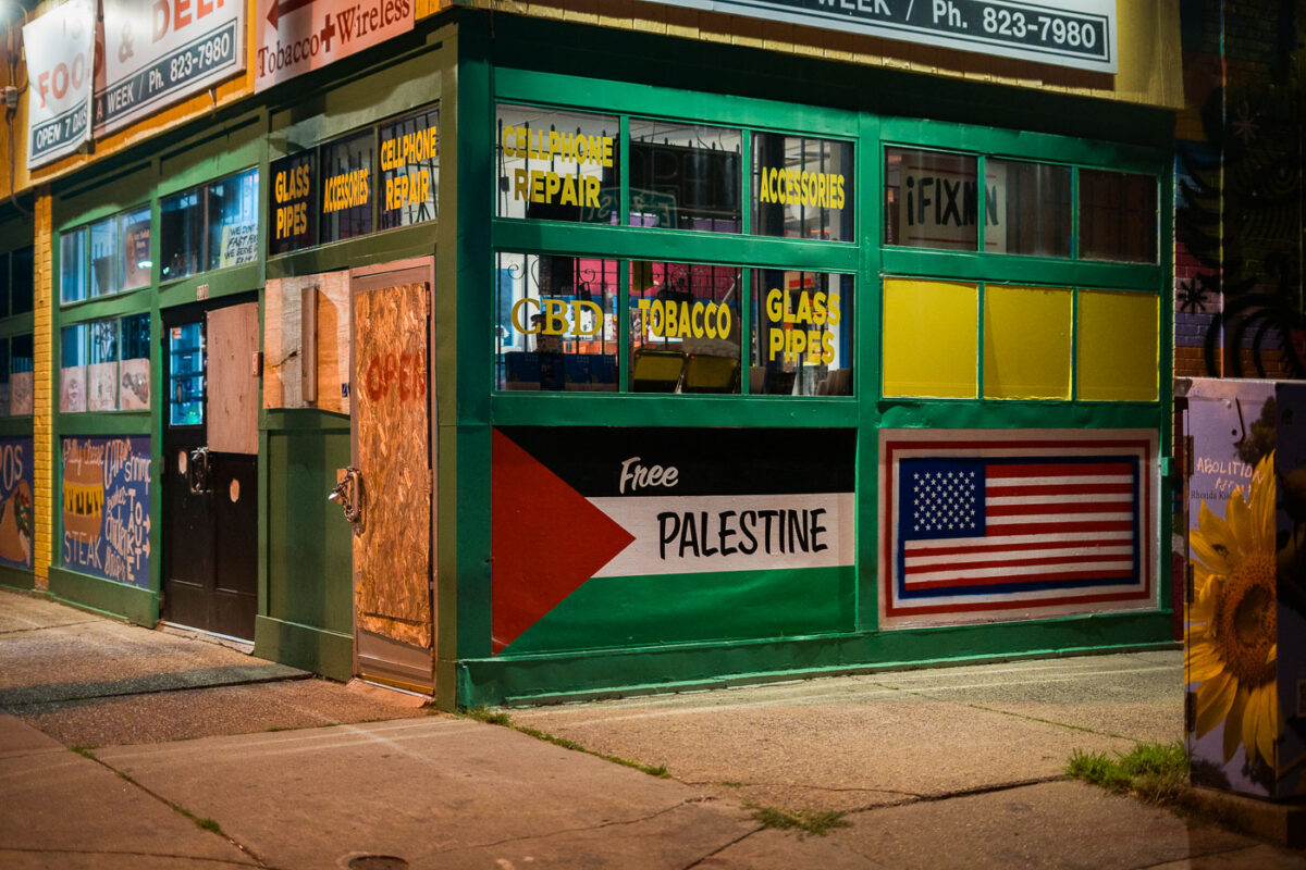 A corner store in South Minneapolis with a Palestine and American flag on the side.