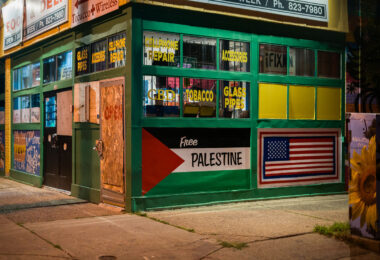 A corner store in South Minneapolis with a Palestine and American flag on the side.