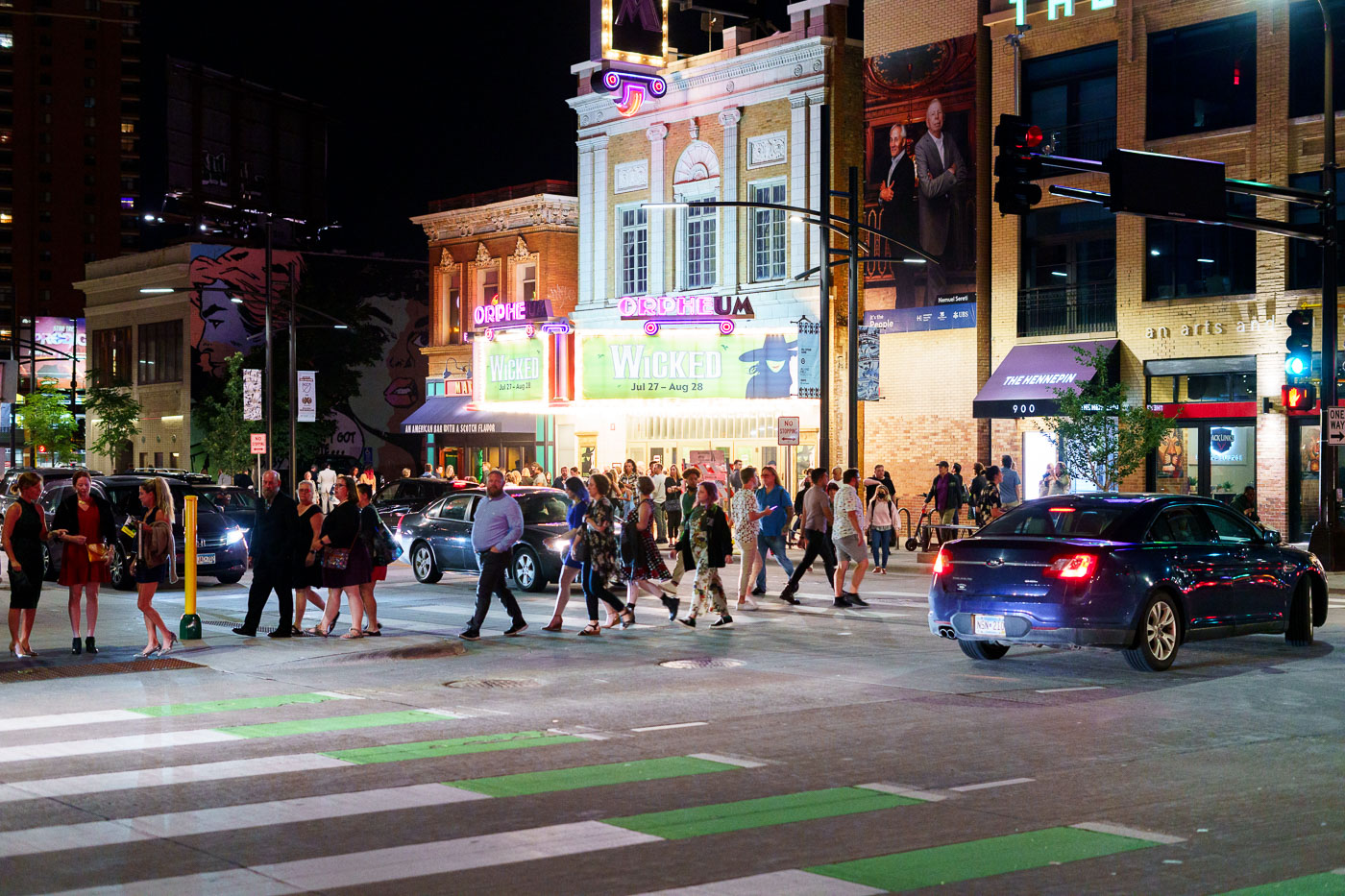 Large crowd leaves a thgeater on Hennepin Ave in Downtown Minneapolis