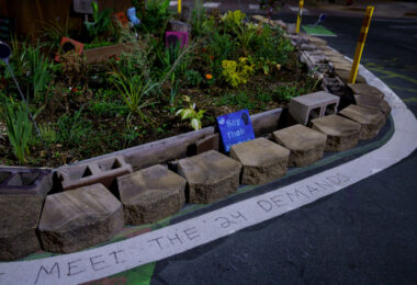 As the city begins “Monthly learning tables” as part of its “38th & Chicago Re-Envisioned” project, more than a year after streets were reopened to vehicles, the ask from those at George Floyd Square continues to be the same as it has been since August 7, 2020: Meet the demands.