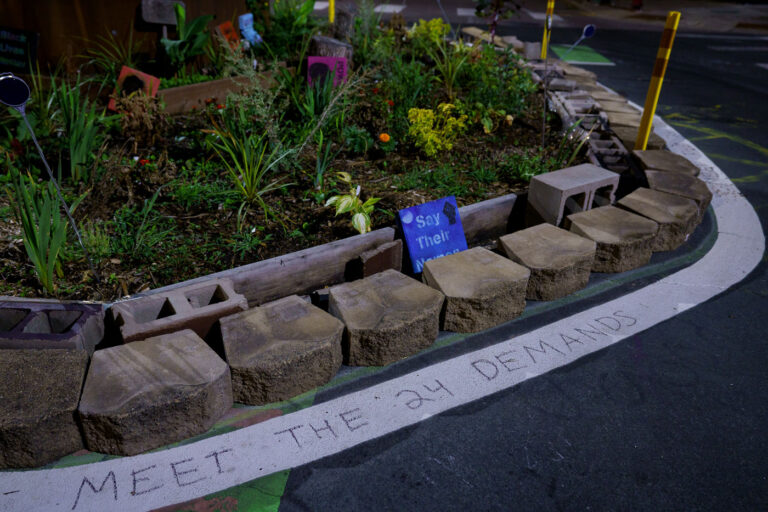 Meet The Demands in Chalk at George Floyd Square 2 As the city begins “Monthly learning tables” as part of its “38th & Chicago Re-Envisioned” project, more than a year after streets were reopened to vehicles, the ask from those at George Floyd Square continues to be the same as it has been since August 7, 2020: Meet the demands.