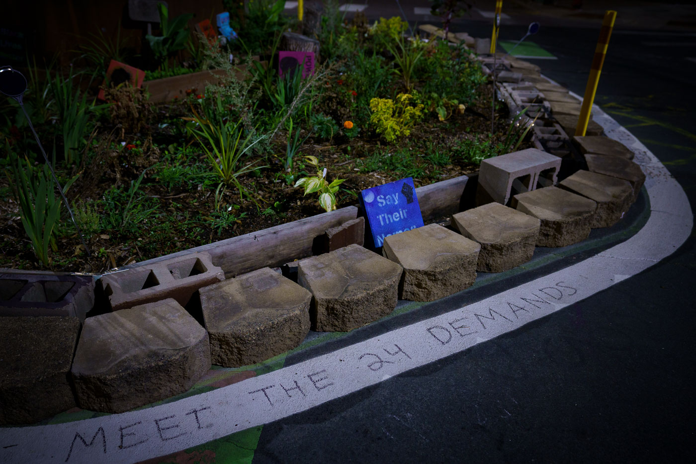 Meet the 24 Demands written on the cement at George Floyd Square