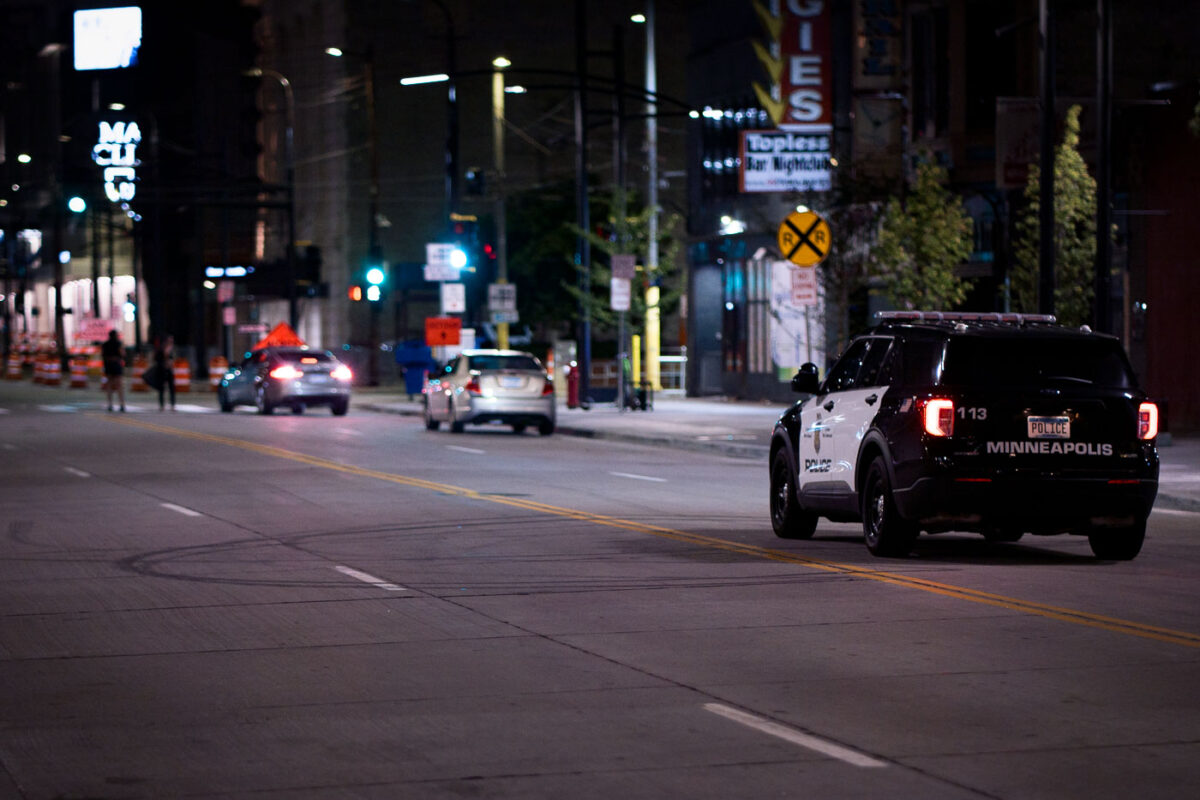 A Minneapolis police squad car drives down Hennepin Avenue in Downtown Minneapolis.