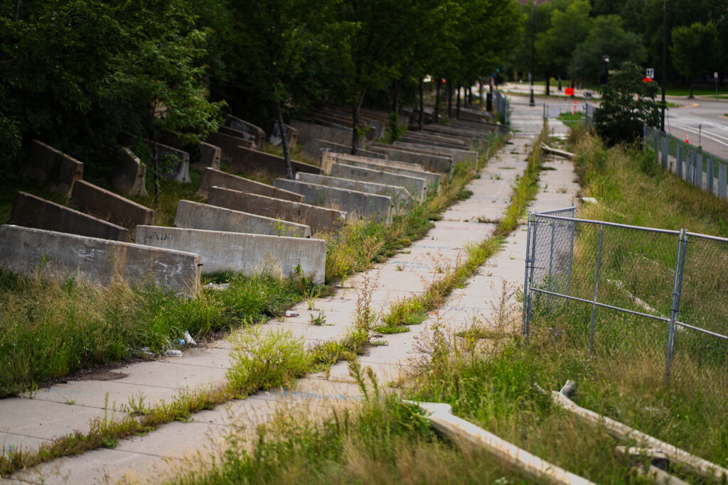 2 years ago the city closed a large part of the Little Earth Trail after tents returned to the Wall of Forgotten Natives, where homeless gathered in 2018. With the fencing, the city also made it a graveyard of old metal street poles and concrete barricades. It's still closed off.