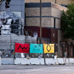 An art installation on the fencing around the Minneapolis Police Third Precinct. The Precinct was destroyed during riots following the murder of George Floyd.