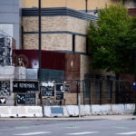 Minneapolis Police Third Precinct with art banners on the fencing. The precinct has been vacant since it was lit on fire during protests that followed the May 25th, 2020 murder of George Floyd.